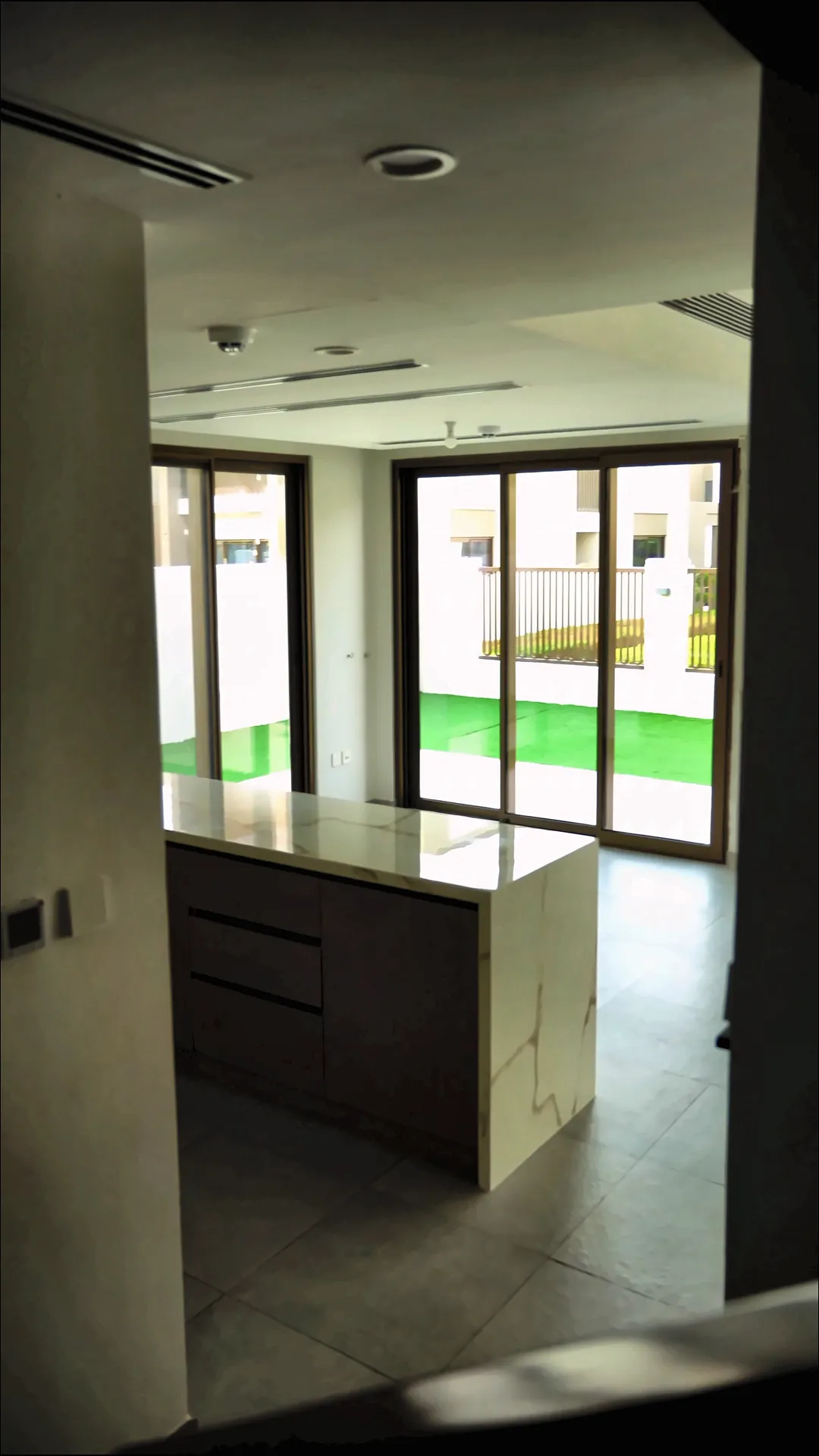 Open living area with kitchen island and garden doors